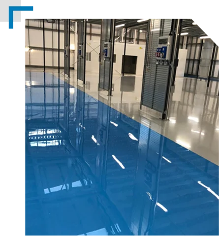 blue and gray epoxy floor in a large commercial or industrial space