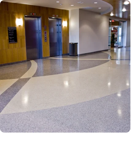 commercial epoxy terrazzo floor with curved white, light gray, and darker gray flake patterns