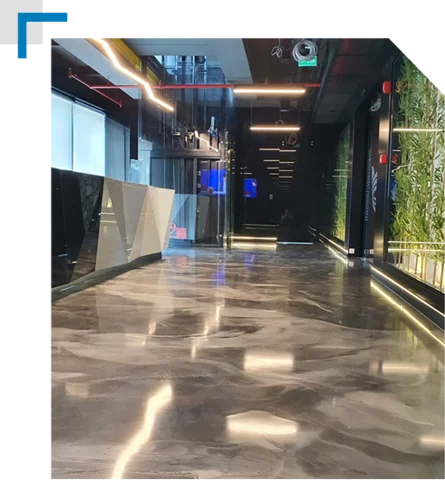 Durable smoke-grey commercial epoxy flooring installed in a clean, modern commercial hallway.