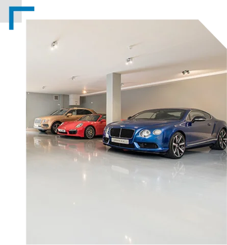 gold sedan parked on a clean, bright, glossy light gray epoxy floor