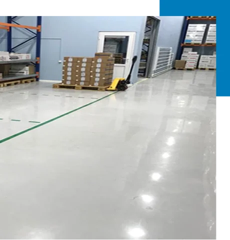 white epoxy floor in a warehouse with a green dividing line